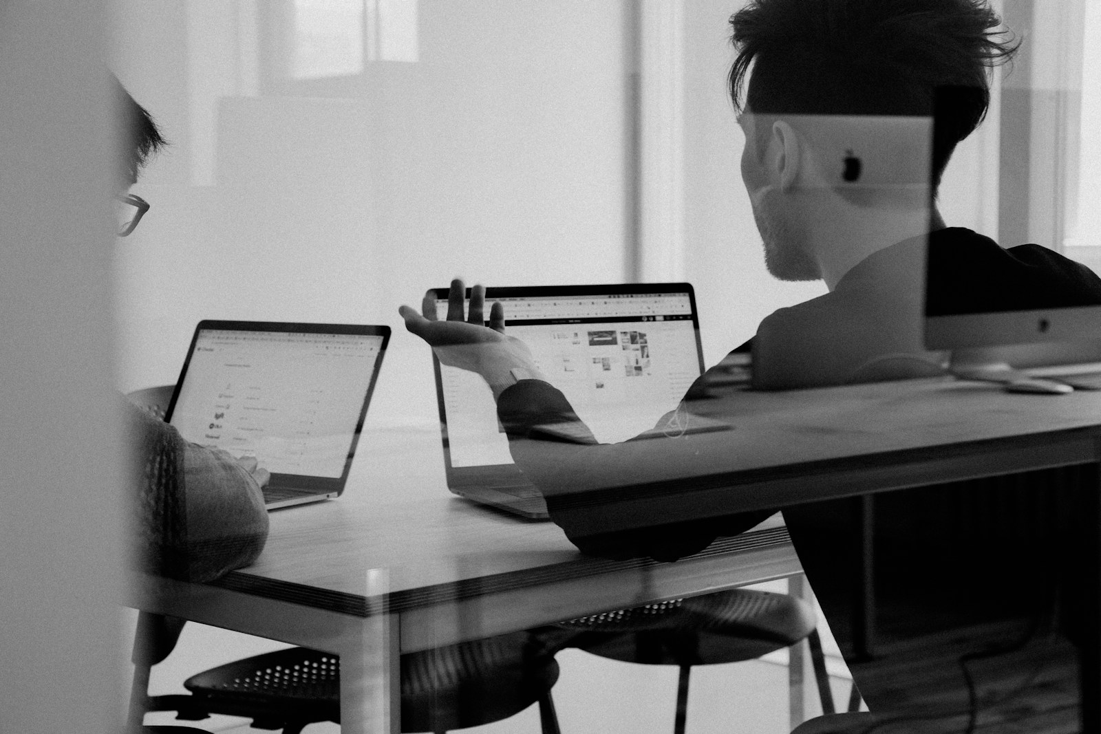 A team reviewing notes and a laptop together